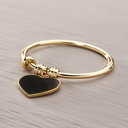 Strength in love. Cuff bracelet with a black heart